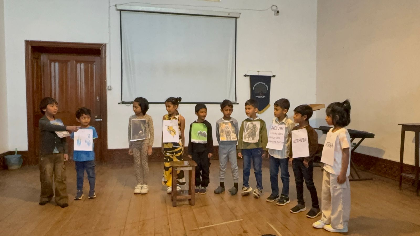 A narrator introduces the student dressed as a water drop to the assembly