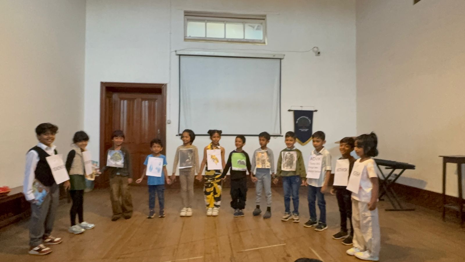 The full cast holds hands and smiles at the end of the performance