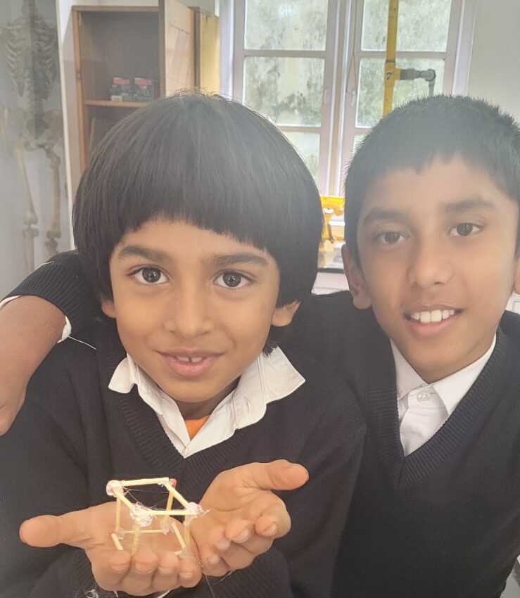 Two Grade 5 students smiling with their finished matchstick cube