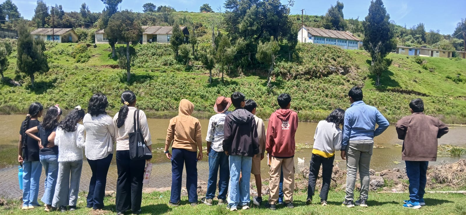 Students looking out over the research station's pond and hillside