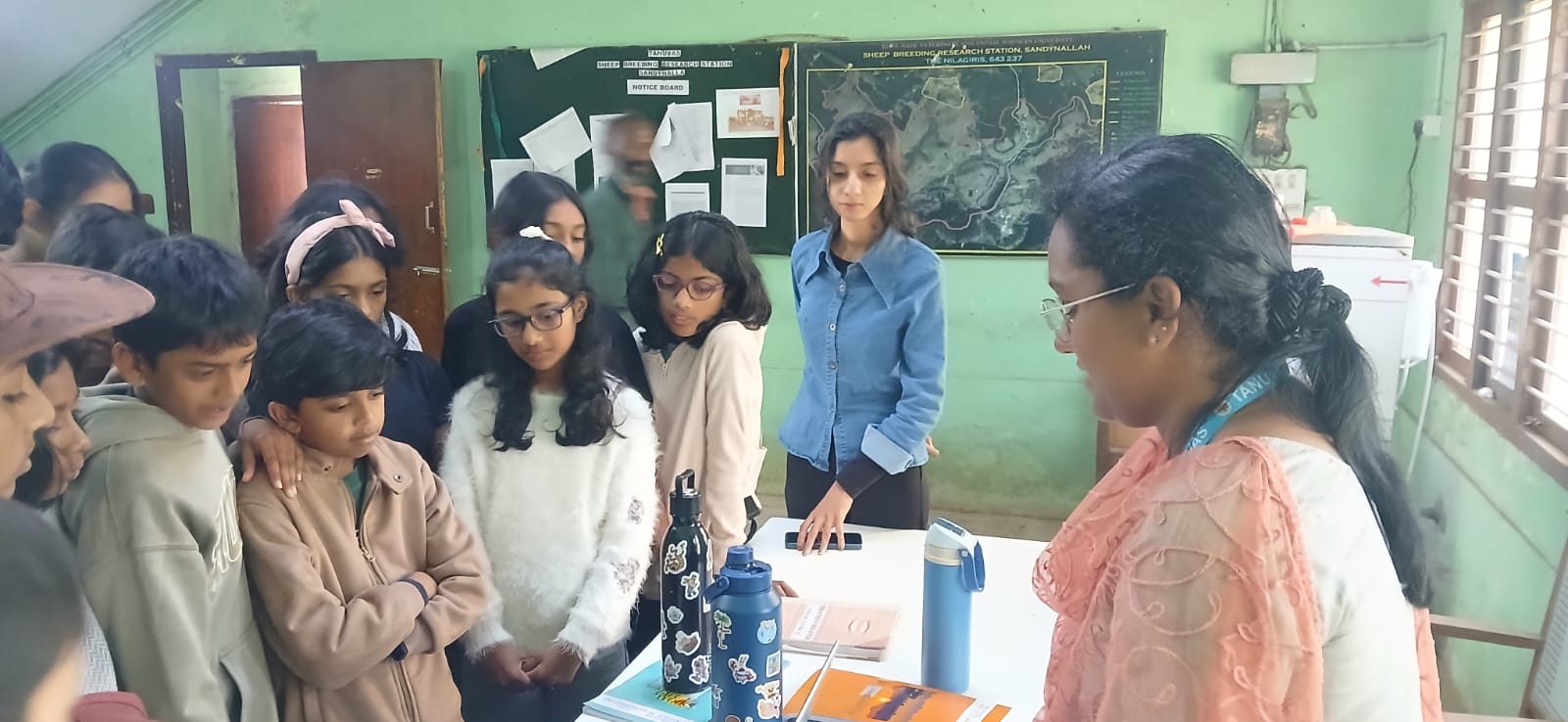 Students listening to a briefing inside the research station office