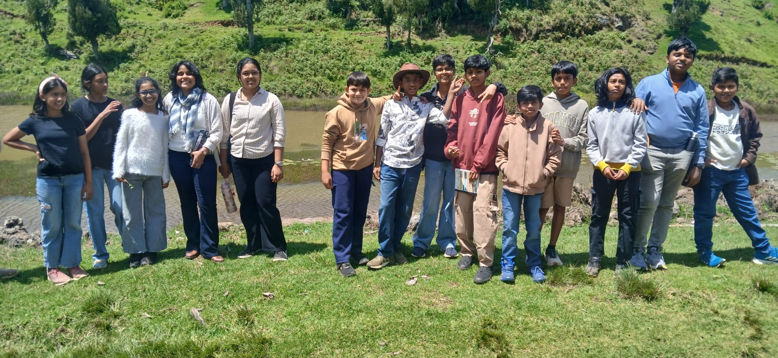 The group posing together by the station's pond