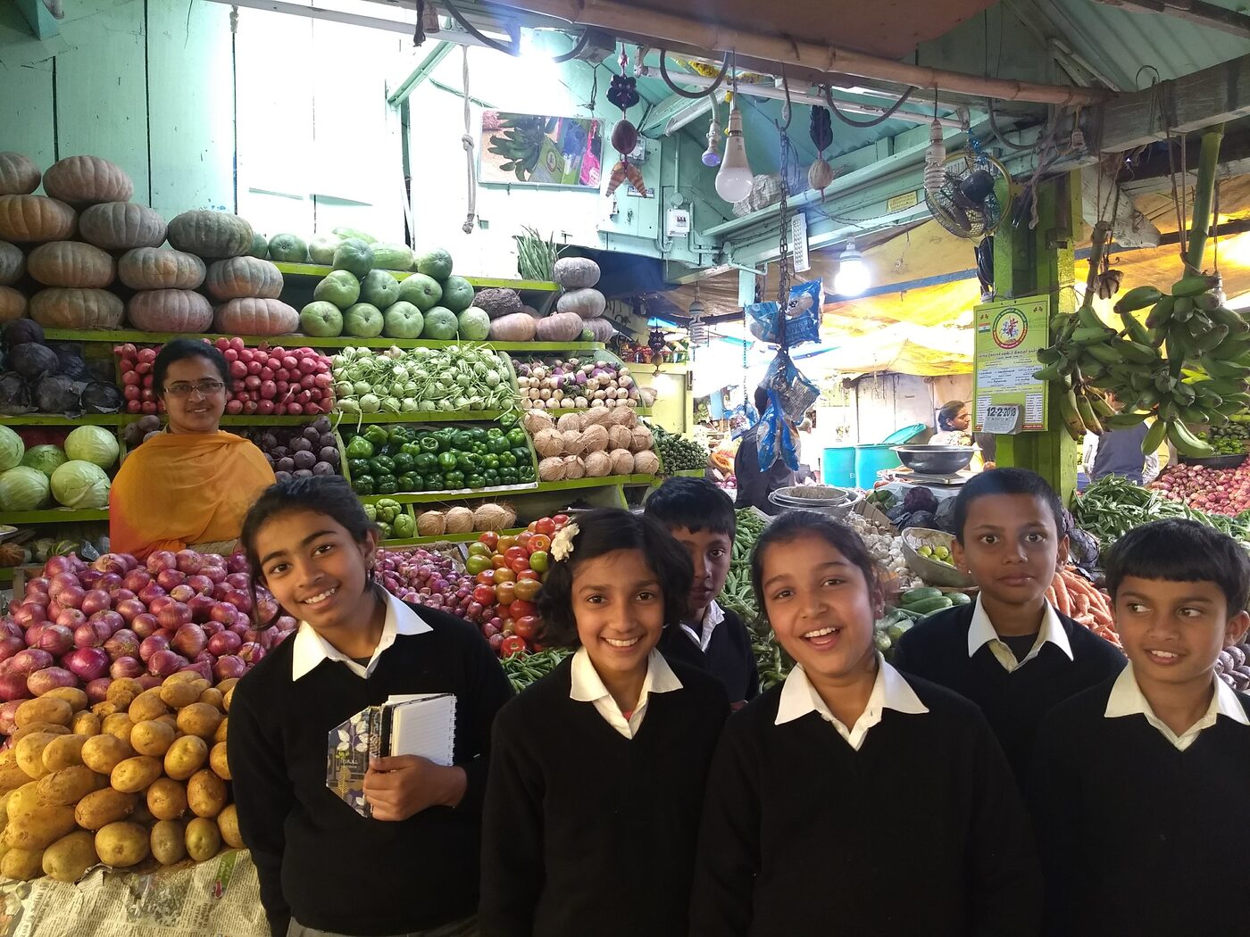 Jayanthi at her vegetable stall with students