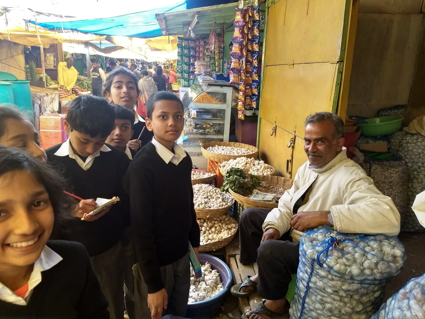 Anand at his garlic stall with students